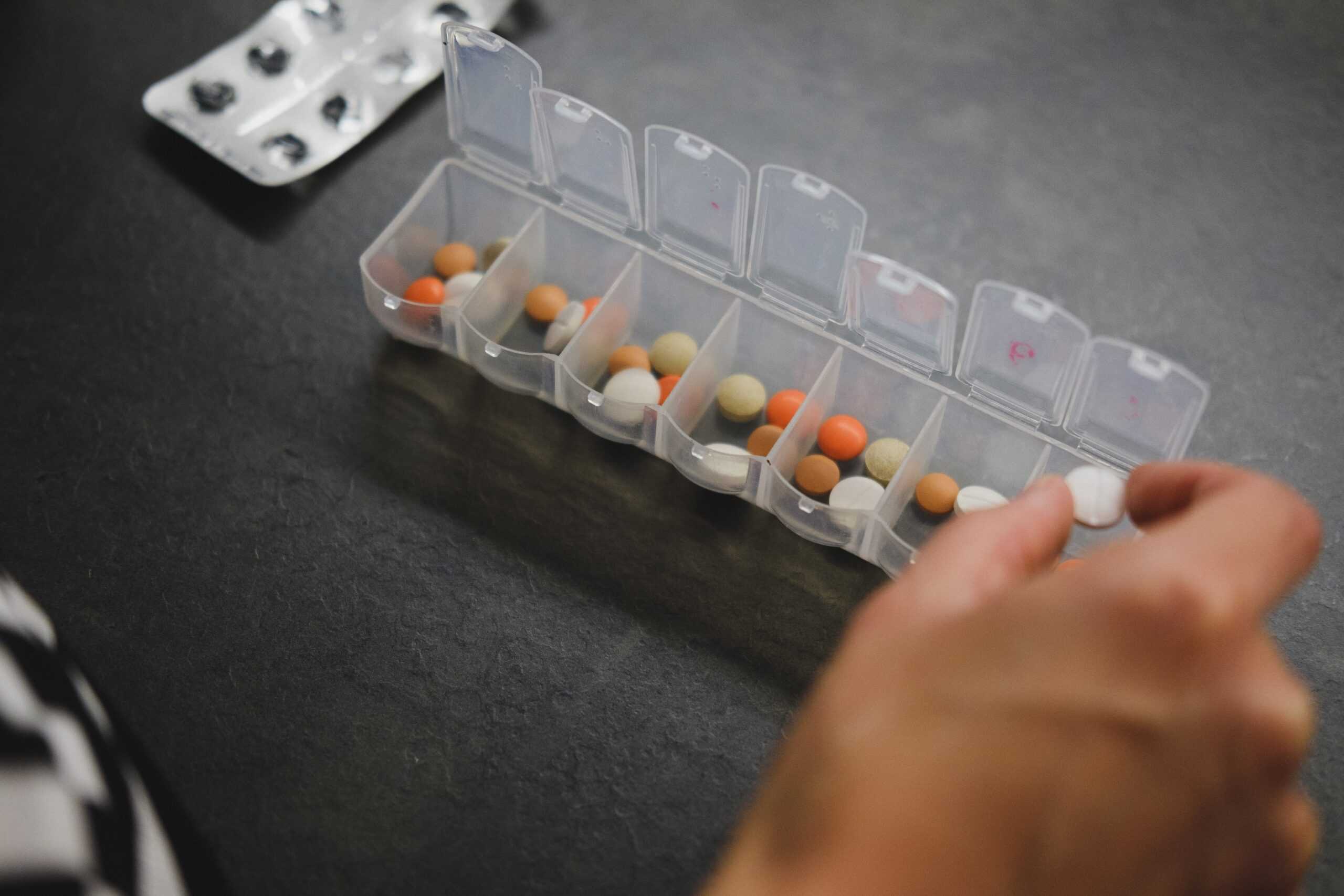 A man examining the Saar pill closely.